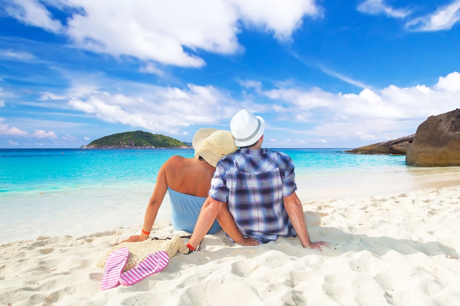 Couple in hug sitting together at the Caribbean Sea